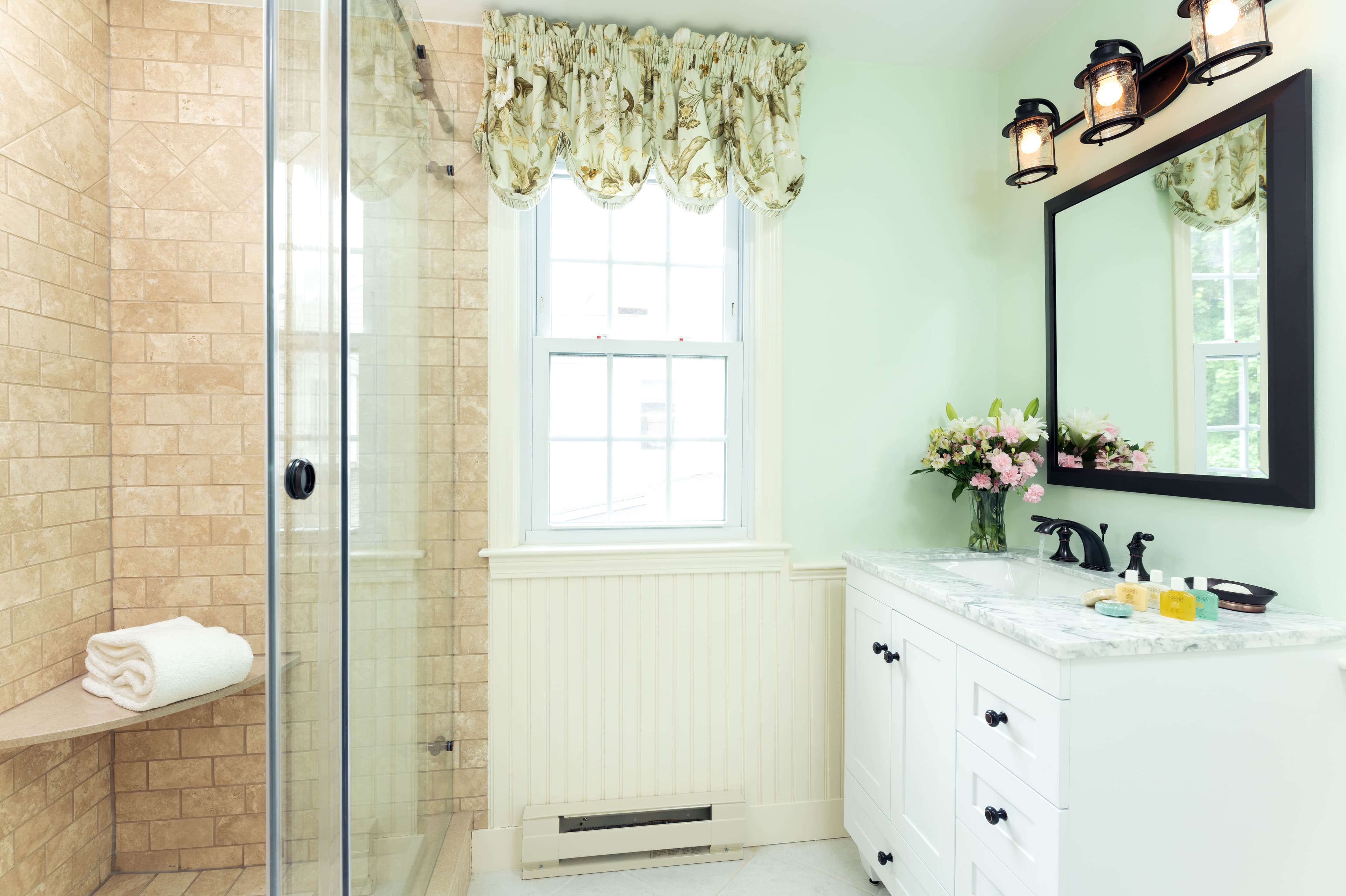 Marble white vanity, large window, step-in glass enclosed shower