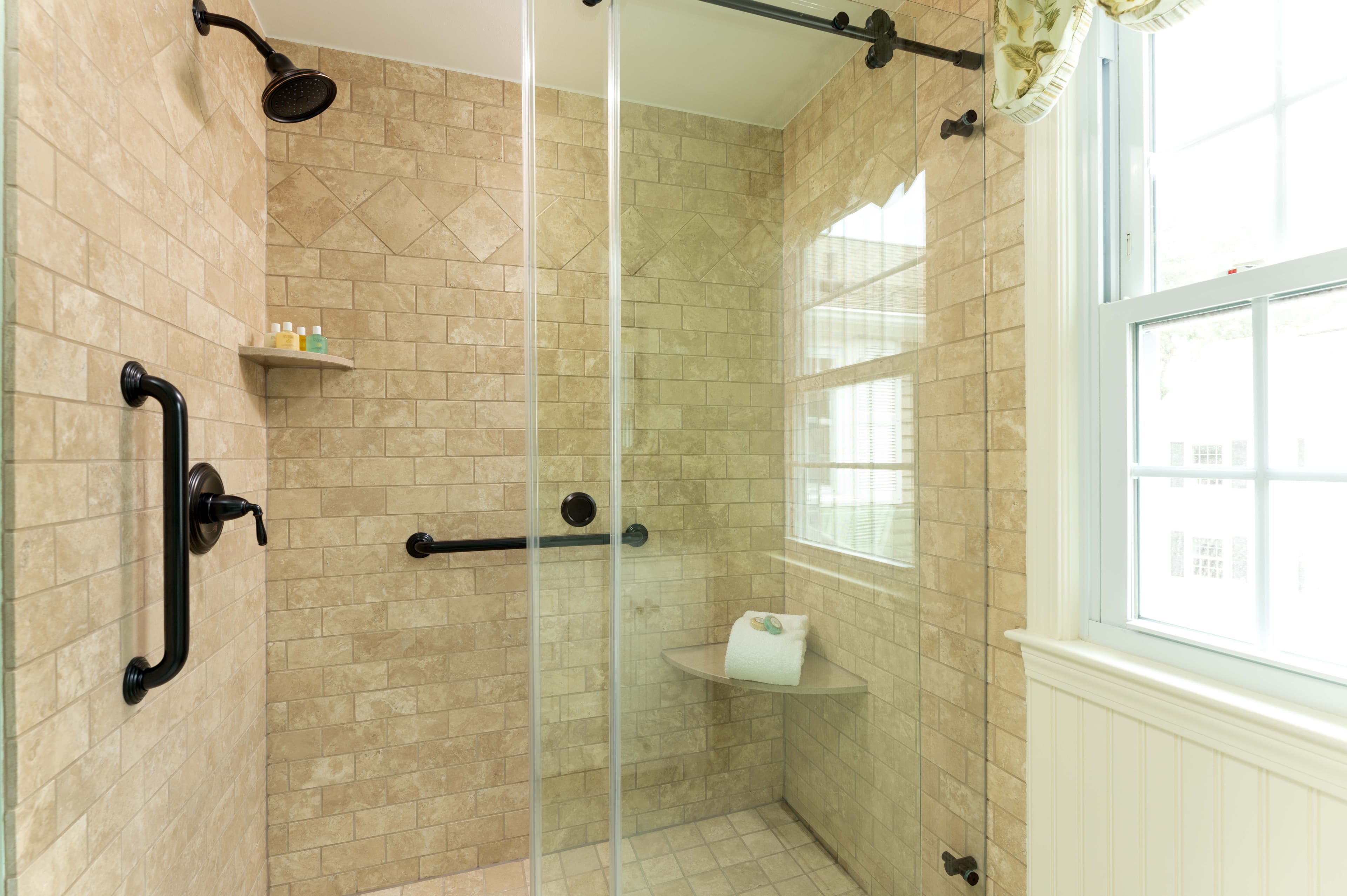 Glass enclosed spa shower clear glass with brown stone