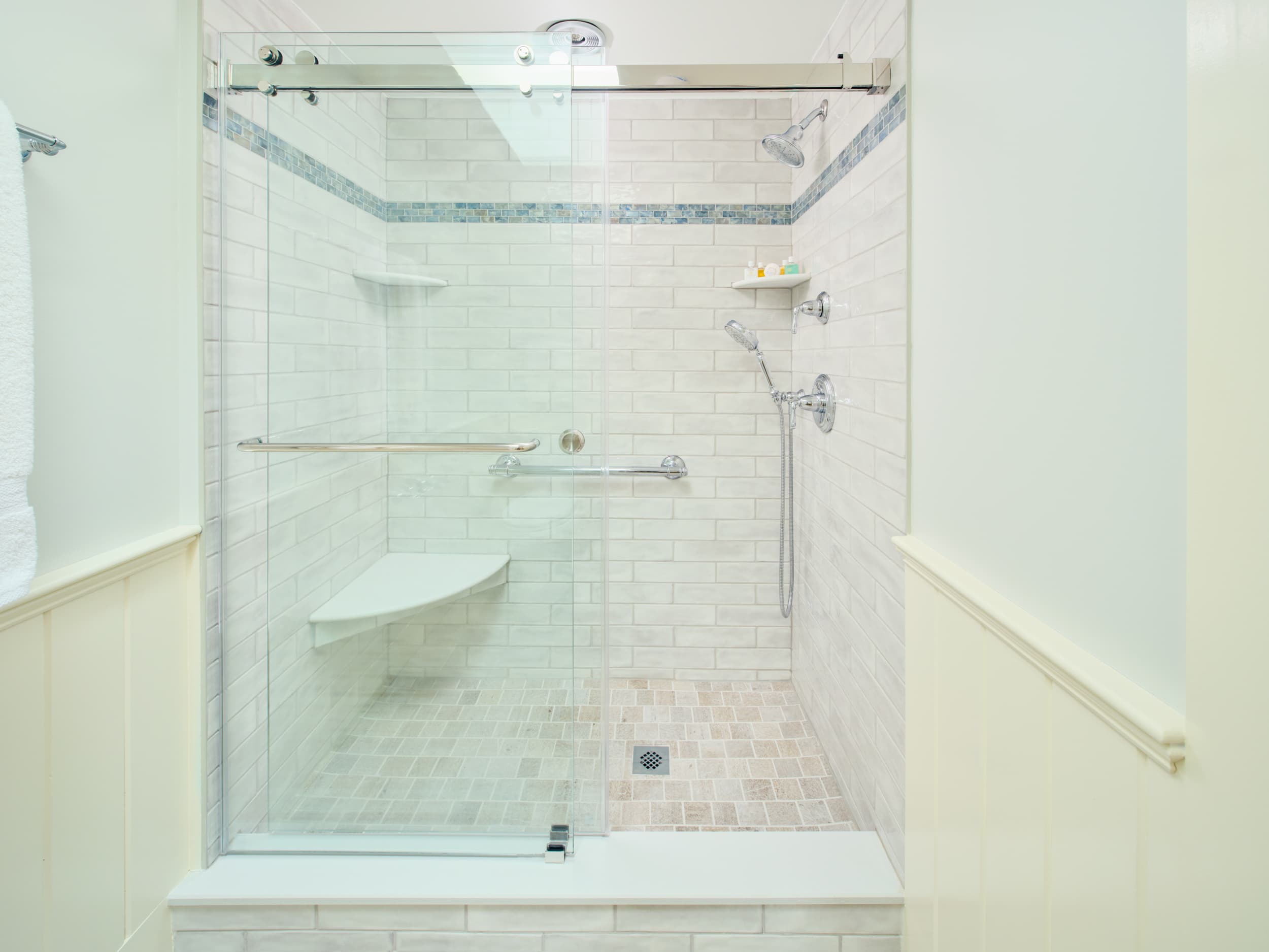 Glass Enclosed shower with off white tile