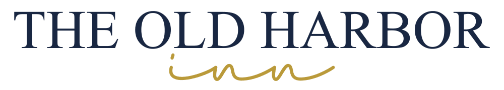 Logo for The Old Harbor Inn featuring bold blue and elegant gold text.