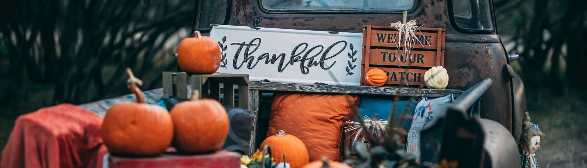 Old truck decorated for thanksgiving with pumpkins